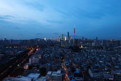 High angle view of illuminated buildings against sky at night