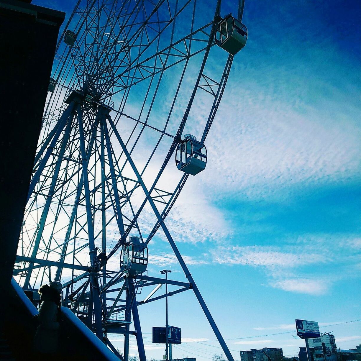 amusement park, arts culture and entertainment, low angle view, sky, ferris wheel, leisure activity, outdoors, amusement park ride, built structure, day, no people, big wheel, chain swing ride