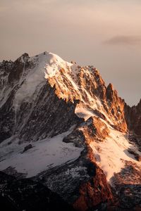 Scenic view of snowcapped mountains against sky during sunset