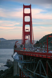 View of bridge over sea against cloudy sky