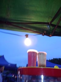 Low angle view of illuminated lamp against sky