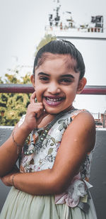 Portrait of smiling girl sitting outdoors