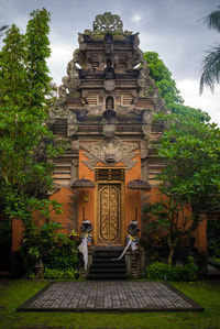 Statue outside temple against sky