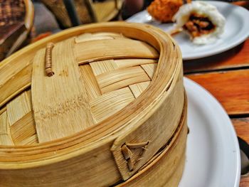 Close-up of bamboo steamer by food on table