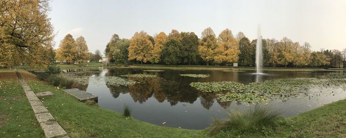 Scenic view of fountain in lake against sky during autumn