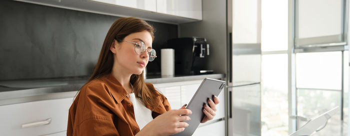 Young woman using mobile phone in office