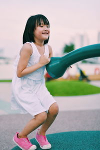 Full length of playful girl at playground during sunset