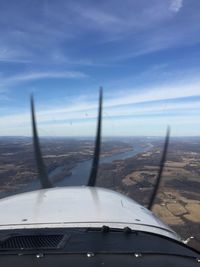 Cropped image of airplane wing over landscape