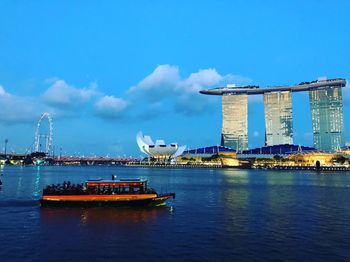 Boat in river with city in background