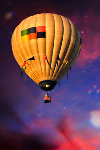 Low angle view of hot air balloon flying against sky