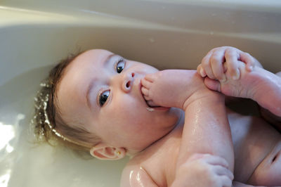 Close-up portrait of cute baby girl in bathtub