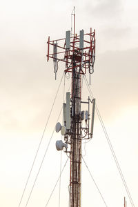 Low angle view of communications tower against sky