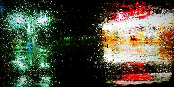 Full frame shot of wet glass window during rainy season