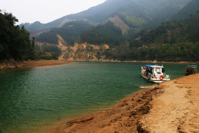 Boat in lake against mountains