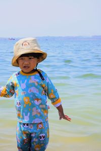 Portrait of boy standing at beach