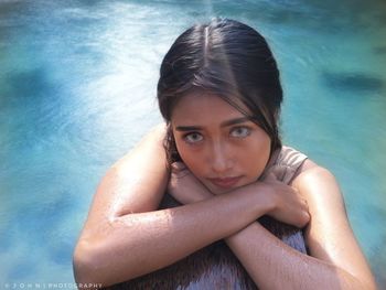 Portrait of beautiful young woman in swimming pool