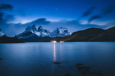 Scenic view of snowcapped mountains against sky at night