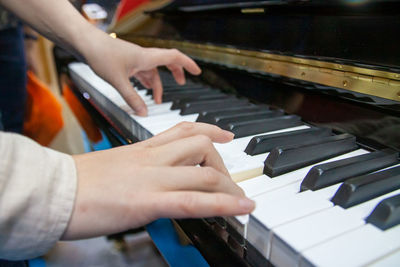 Close-up of hands playing piano