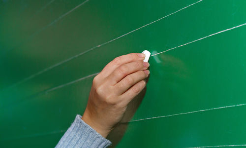 Cropped image of teacher drawing on blackboard