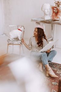 Portrait of young woman sitting at home