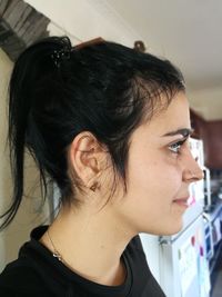 Side view of young woman at home