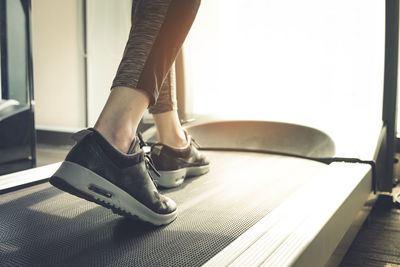 Low section of woman exercising in gym