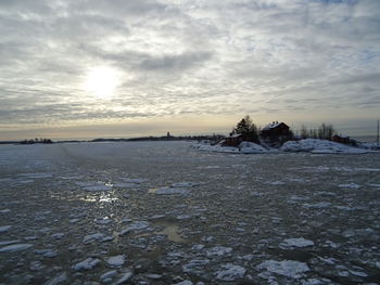 Scenic view of frozen lake against sky during sunset