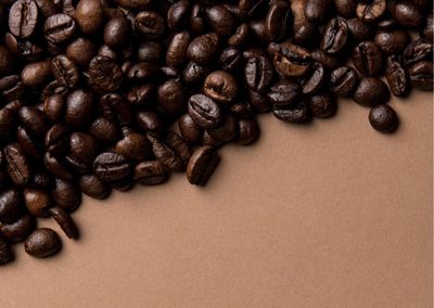 Directly above shot of coffee beans on yellow background