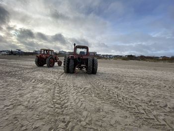 Tractor on beach against sky  /  ahlbeck  /  usedom  /   baltic sea