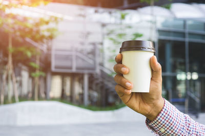 Hand holding coffee cup