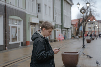 A walk around the city, a teenager looks at the phone throughout the walk, a millennium