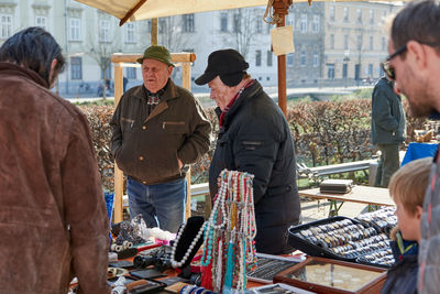 People standing on street market in city