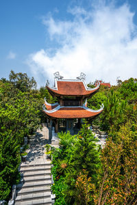 Temple by building against sky