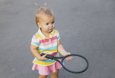 Portrait of boy playing tennis