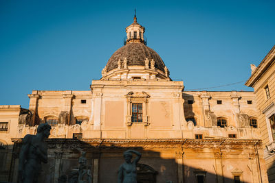 Low angle view of historic building against clear blue sky