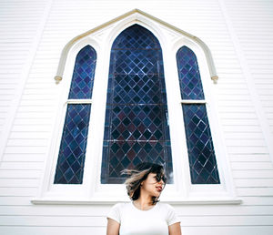 Low angle view of woman standing against building