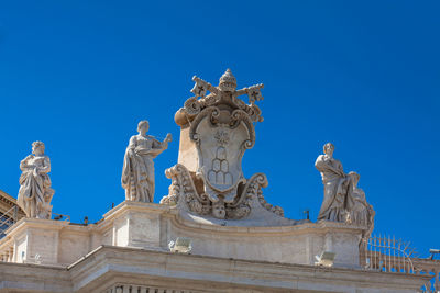 Low angle view of statue against blue sky