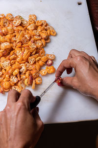 Cropped hands of man preparing food on table