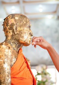 Statue of buddha holding sculpture