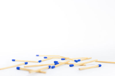 Close-up of blue colored pencils against white background