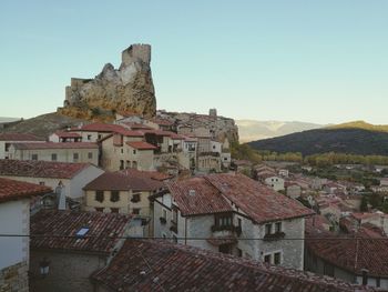 Houses in town against clear sky