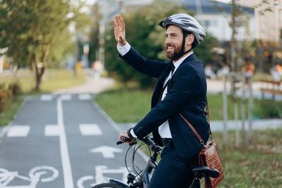 Side view of young man riding bicycle
