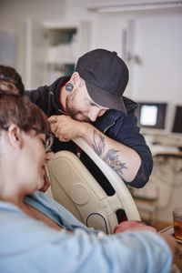 Father in hospital looking at newborn baby