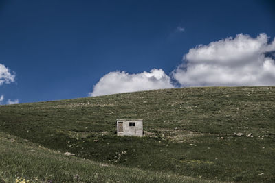 House on field against sky