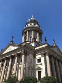 Low angle view of historic building against clear blue sky