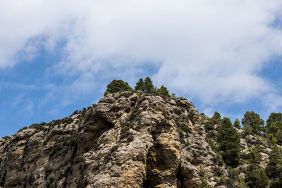 Low angle view of rock formation against sky