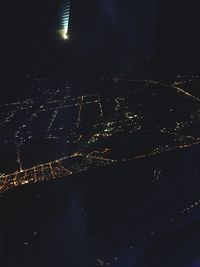 Illuminated city against sky at night