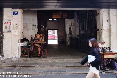 Rear view of people working on building