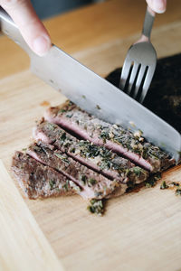 High angle view of person preparing food on cutting board