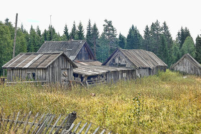 Panoramic view of cottage on field against sky